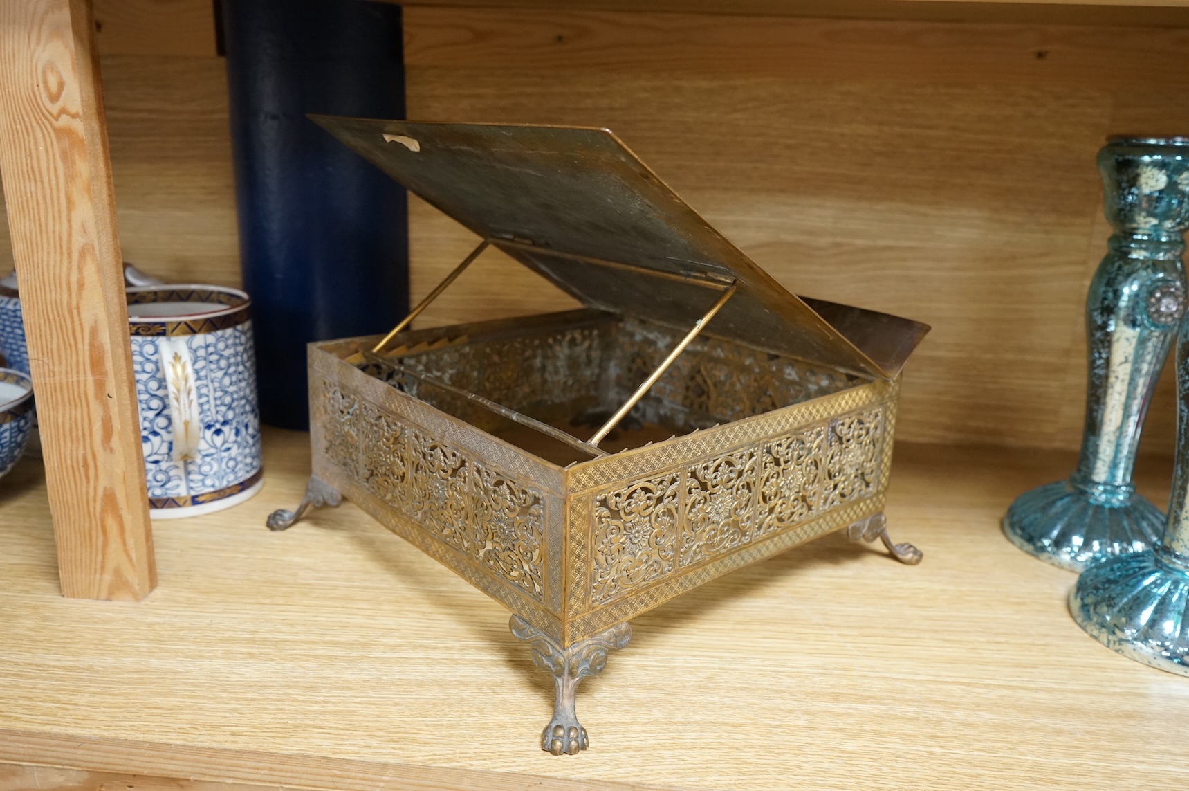 A French Limoges enamel and gilt metal lectern stand with glass cabochons and paw feet, 30cm wide